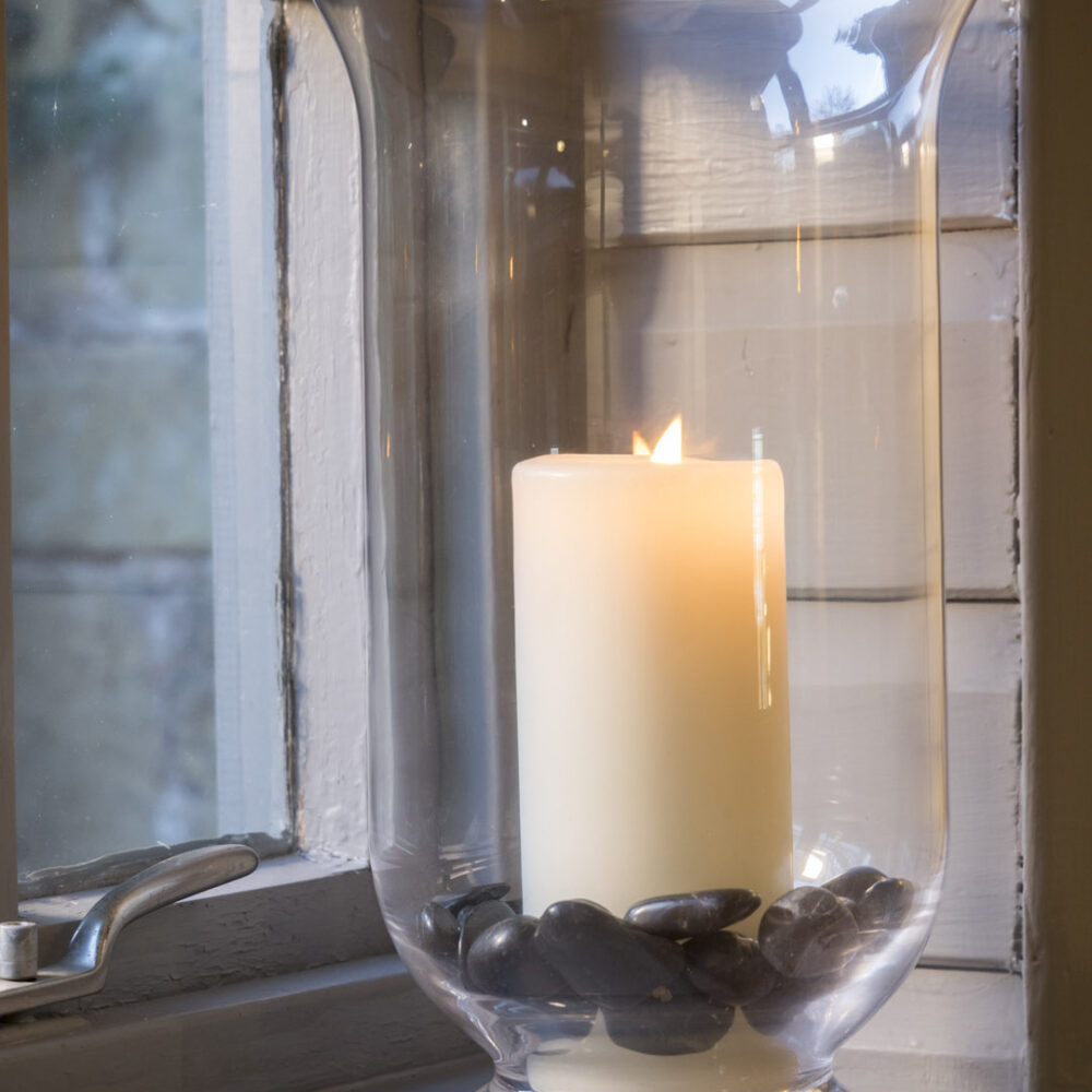 Bedouin large hurricane lamp - Clear glass candle-holder alight on a window sill