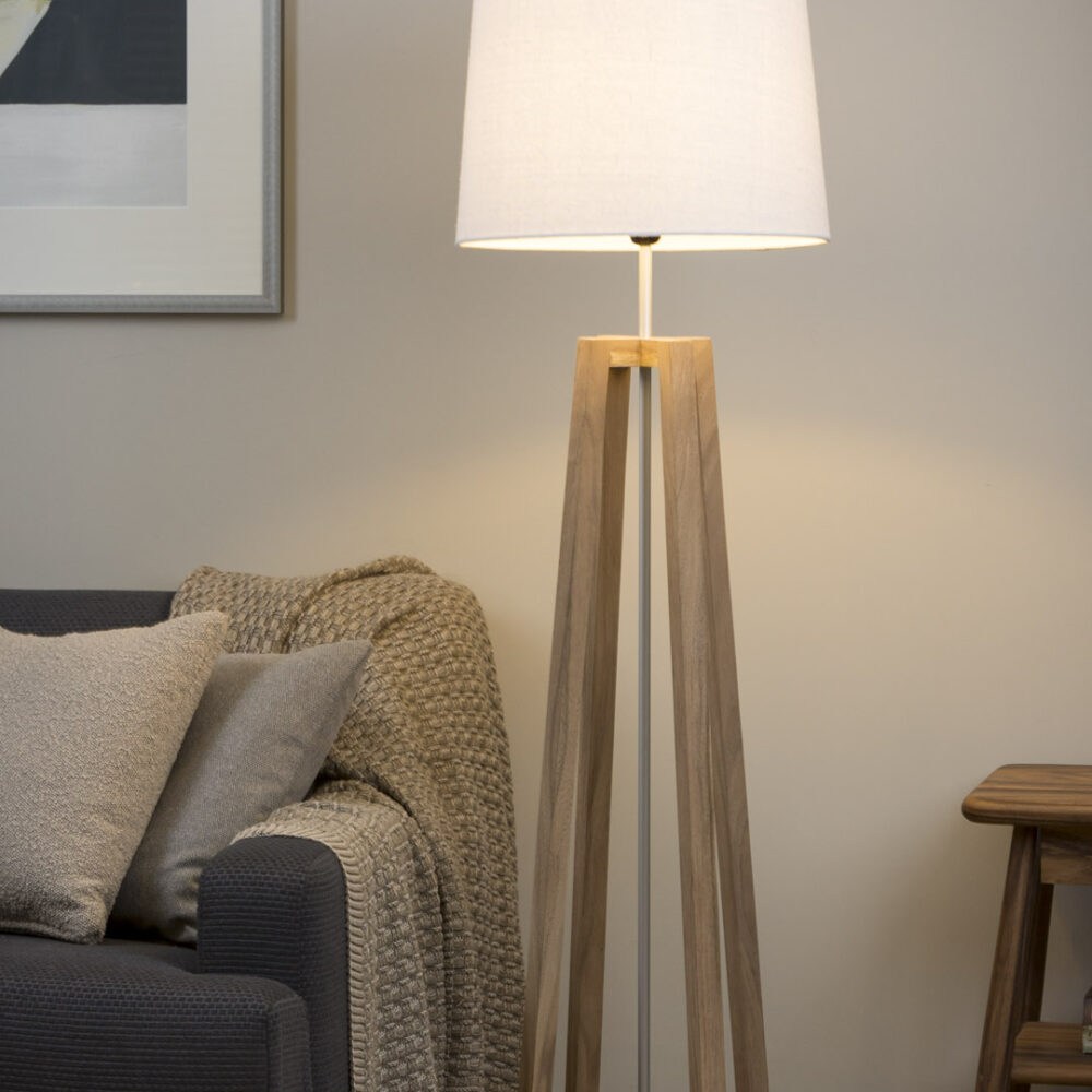 Cross wooden floor lamp in natural in contemporary room setting.
