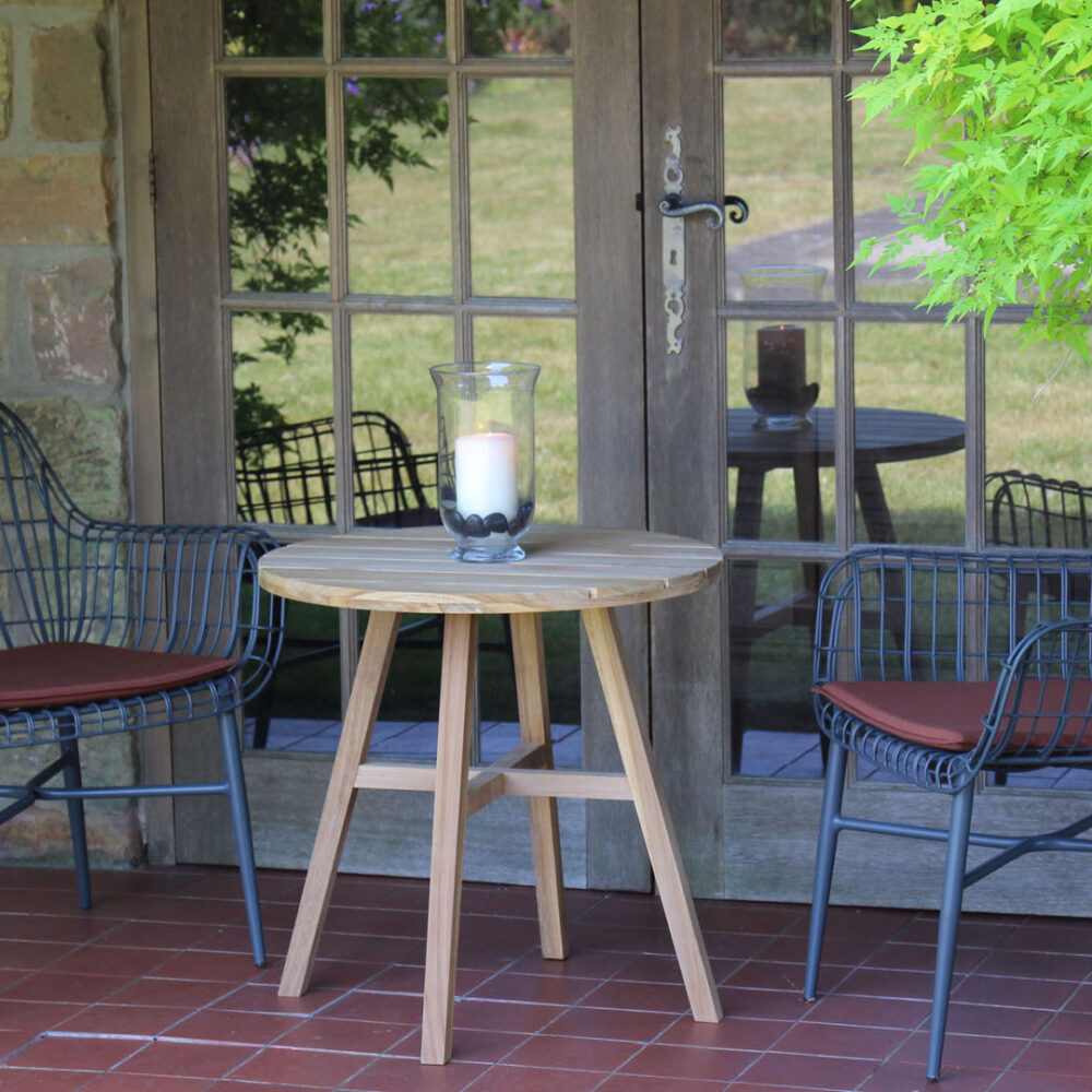 A mood shot of Tunis armchairs in graphite with olefin terracotta pads and Kinsale 60 table.