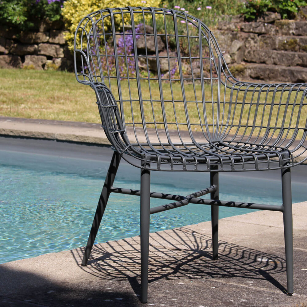 Tunis armchair graphite - in front of an outdoor pool