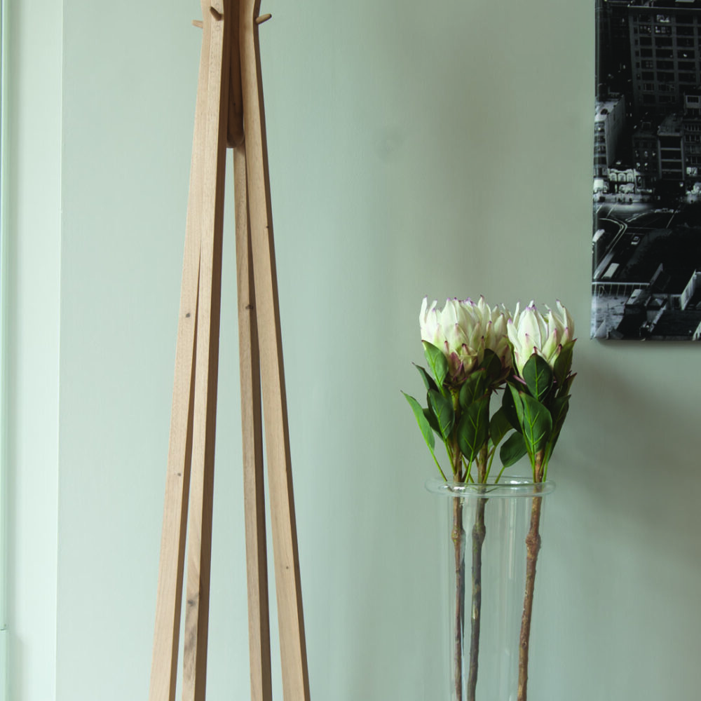 Totem coat and hat stand. A striking and stylish wooden coat stand pictured in a hallway.