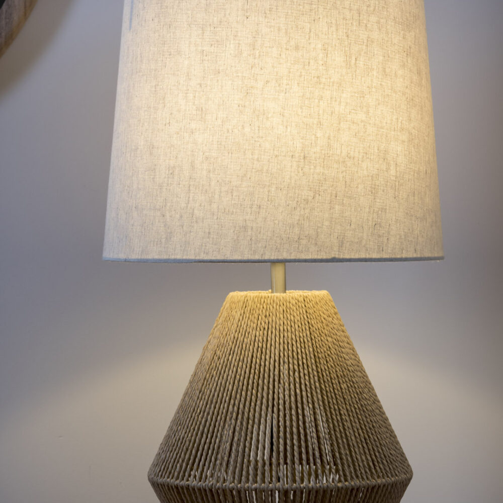 Mood photo of the Giza woven table lamp - Large lamp in natural weave casting a warm and soft light