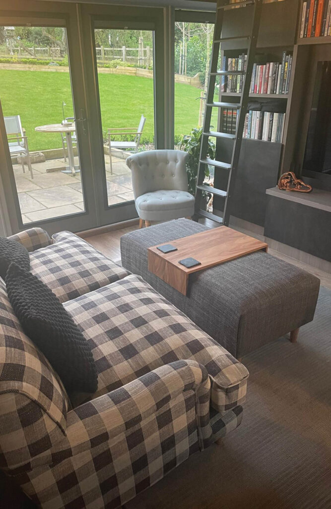 Lewes 2 seat sofa - upholstered in Norfolk check fabric, Marylebone footstool in Newport greys fabric. Pictured in customers chic living room and library.