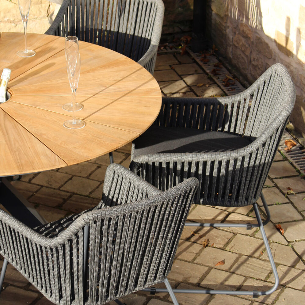 Biarritz outdoor dining table with concealed ice bucket & genoa dining armchairs - lifestyle shot